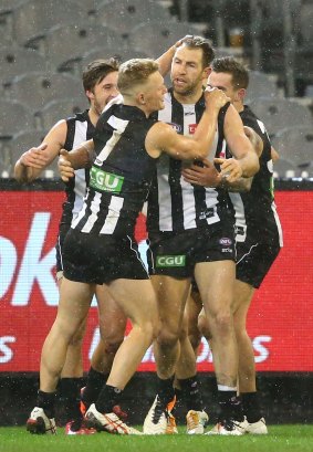 Magpies congratulate Cloke after he scored a goal.