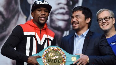 Squaring up: Floyd Mayweather Jr. and Manny Pacquiao pose with the WBC championship belt.