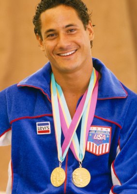 Greg Louganis poses with his two gold medals during the 1984 Summer Olympics.