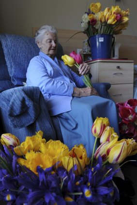 A resident of the Calvary
Retirement Community at Bruce, 88-year-old Violet Howes, is surrounded by tulips.