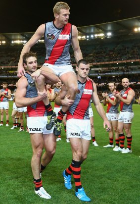 Dustin Fletcher of the Bombers is chaired off the ground in his 400th game.