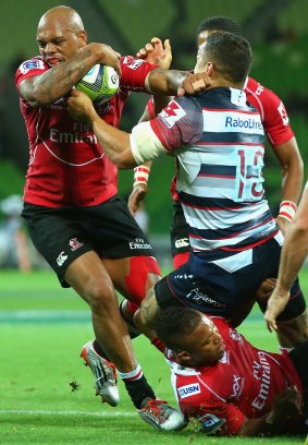 Lionel Mapoe of the Lions is tackled by Tamati Ellison of the Rebels  during the Super Rugby match on Friday.
