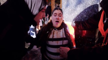 An anti-racism protester Kat Galea, is cared for after being pepper sprayed. 
