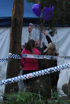 Mark Leveson (second from right) and his wife Faye (right) release balloons at the crime scene where human remains have been unearthed.