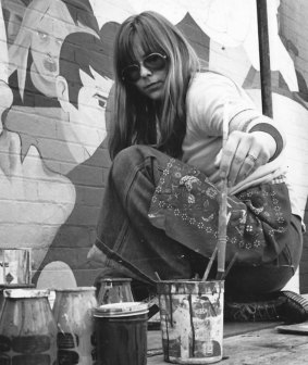 Charlotte Clemens painting a mural on a Lyon Street house, circa 1976.