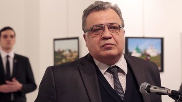 Russian Ambassador to Turkey Andrei Karlov makes an address at the gallery moments before he is shot by Mevlut Mert Altintas, seen in the background.