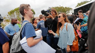 Logan Locke, 17, a student who survived the shooting at Marjory Stoneman Douglas High School, talks to media before boarding a bus.