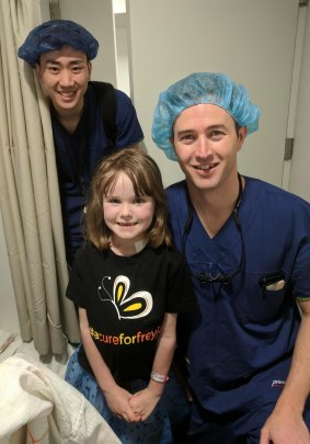 Canberra girl Freyja Christiansen says goodbye to doctors in Melbourne including Dr Ben Dixon (right) who performed the Australia-first operation on her.