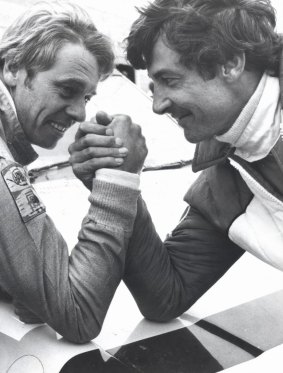 Brothers in arms: Dick Johnson, left, and fellow racing legend Peter Brock enjoy a friendly wrestle in 1987.