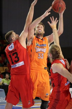 Cairns Taipans forward Mark Worthington drives against Perth Wildcats defenders at the NBL Blitz.