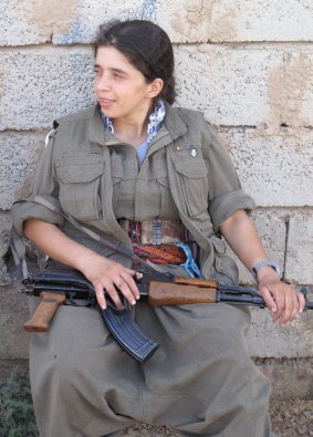 A PKK fighter rests after a night on the frontline.