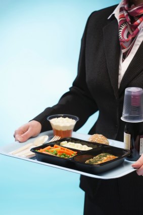 Flight attendant with food tray.
