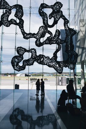 Lucy Irvine with her work, Surface Strategies, which has been installed at the Canberra Airport as part of the Design Canberra Festival.