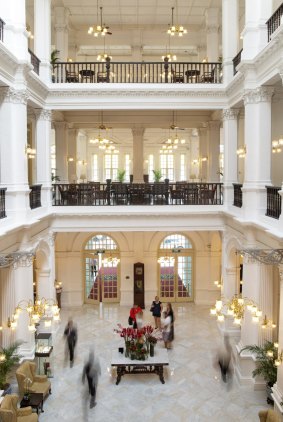 The colonial-style lobby from the second floor walkway of  Raffles Hotel, Singapore.