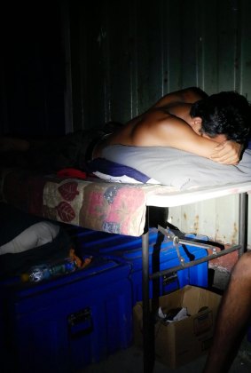 A man sleeping on a fold-out table at the decommissioned Manus Island detention centre.