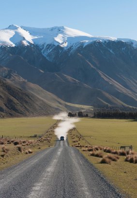 Driving on the Double Hill Run Road with mountains in the background, Methven, New Zealand.