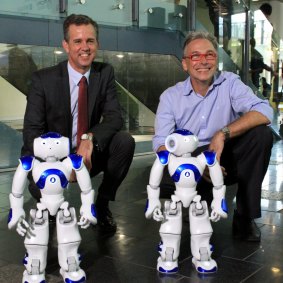 Professor Gordon Wyeth, Executive Dean of the science and engineering faculty at Queensland University of Technology and Australian Centre for Robotic Vision director Professor Peter Corke play with the NAO robots.
