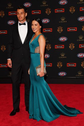 Rare pop of colour ... Robbie Tarrant of North Melbourne and partner Jess Jafer.