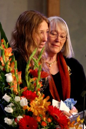 Grandmother Robin Ginn comforts Francesca Hellmuth as she speaks at the funeral for 11-year-old Edison Hellmuth.