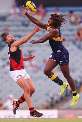 Nic Naitanui wins a tap against Mark Jamar of the Bombers in the NAB Challenge.