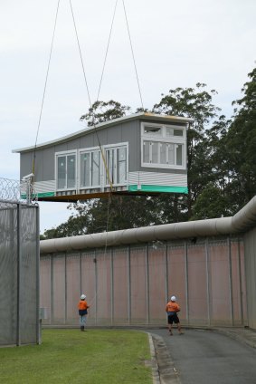 A prison block is lifted into a NSW prison after being built by inmates at St Heliers prison.