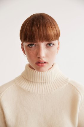 Theron “Mia” cashmere knit, $470. Earrings, model’s own.