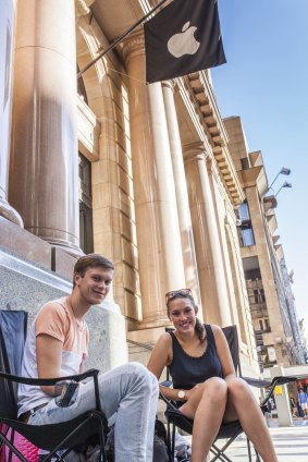German backpackers Moritz Gadow and Kimberley Lewerentz waiting outside the Brisbane Apple Store earlier in the week.