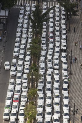 Taxi drivers block a street to protest the Uber ride-sharing service in downtown Sao Paulo, Brazil. Cab drivers complained Uber was unfair competition because its drivers do not have to pay city fees or undergo official inspections. 