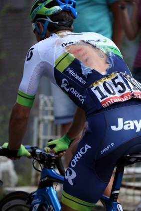 Michael Matthews shows a torn jersey as he attempts to rejoin the peloton after being involved in a crash in stage three.