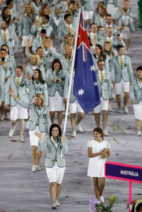 Anna Meares of Australia carries her country's flag during the Opening Ceremony of the Rio 2016 Olympic Games.
