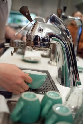 A barista at work in Little Collins. 