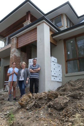 Melinda and Stuart Bunt with their son James at their partly built home in Mona Vale. 