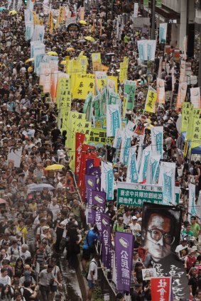 Thousands of protesters march with a picture of Liu Xiaobo along a street during the annual pro-democracy protest in Hong Kong in July.