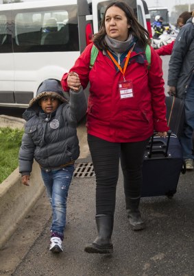 Care workers bring child migrants to a reception point outside the 'Jungle' migrant camp in Calais last week.
