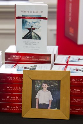 A photo of murdered teen Daniel Morcombe with copies of his parents' book.