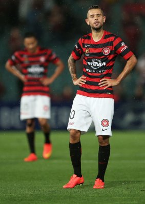 Vitor Saba and his Wanderers teammates show their frustration after the final whistle against the Roar.