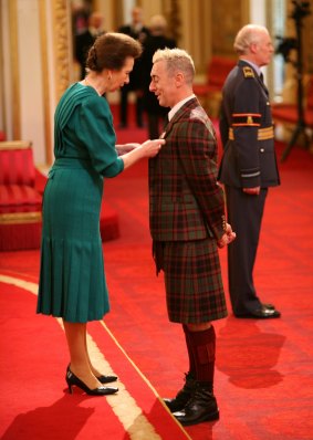 Receiving an OBE from Princess Anne in 2009. 