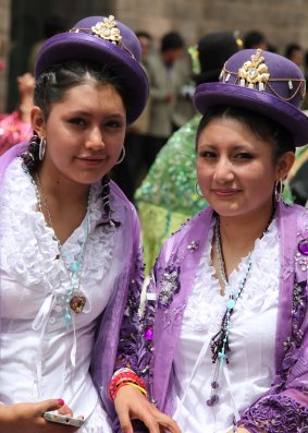 Young women at the Cusco festival wear their hats decorated with  jewels and set at a jaunty angle.