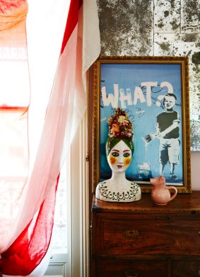 A vintage Italian ceramic vase sits in front of a Banksy print that Jenny bought in London.