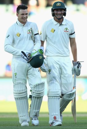 All smiles: Peter Handscomb, left, and Renshaw walk off the Adelaide Oval after claiming victory.
