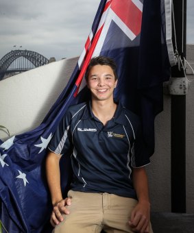 Anti-violence ambassador Liam Knight hoists the Australian flag at the Hotel Palisade to bring awareness to alcohol-fueled violence. 