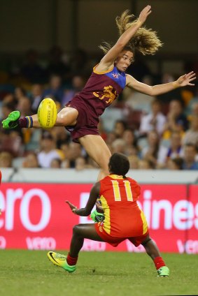 Flyin' Lion: Jenna McCormick jumps for a mark during the women's AFL exhibition match against the Gold Coast Suns at the Gabba last weekend.