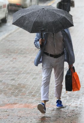 Some pedestrians were prepared as rain hit Brisbane's city centre.