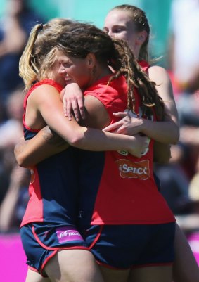 Richelle Cranston hugs teammates after kicking the winning goal.