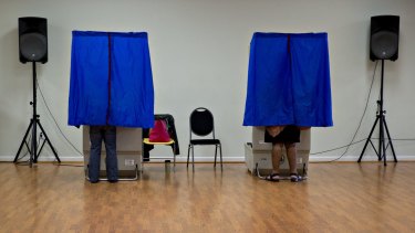 Residents use an electronic voting machine at a polling location in Philadelphia, Pennsylvania.