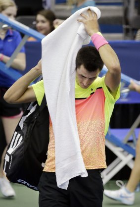 Bernard Tomic leaves the court after losing to Donald Young.