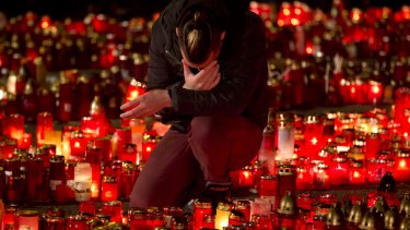 A man mourns outside the Colectiv nightclub in Bucharest on Friday as people mark one week since the deadly fire.