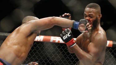 The rematch is off: Daniel Cormier, left, punches Jones at UFC 182