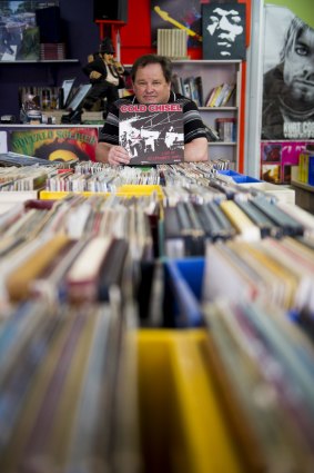 Dynomite Records owner Phil Place with some of the 8000-plus records in his Kambah store. Cold Chisel will release a vinyl box set  next month. 
