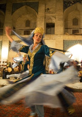 A tradition Uzbek dancer twirls at a folklore show in Bukhara, Uzbekistan.